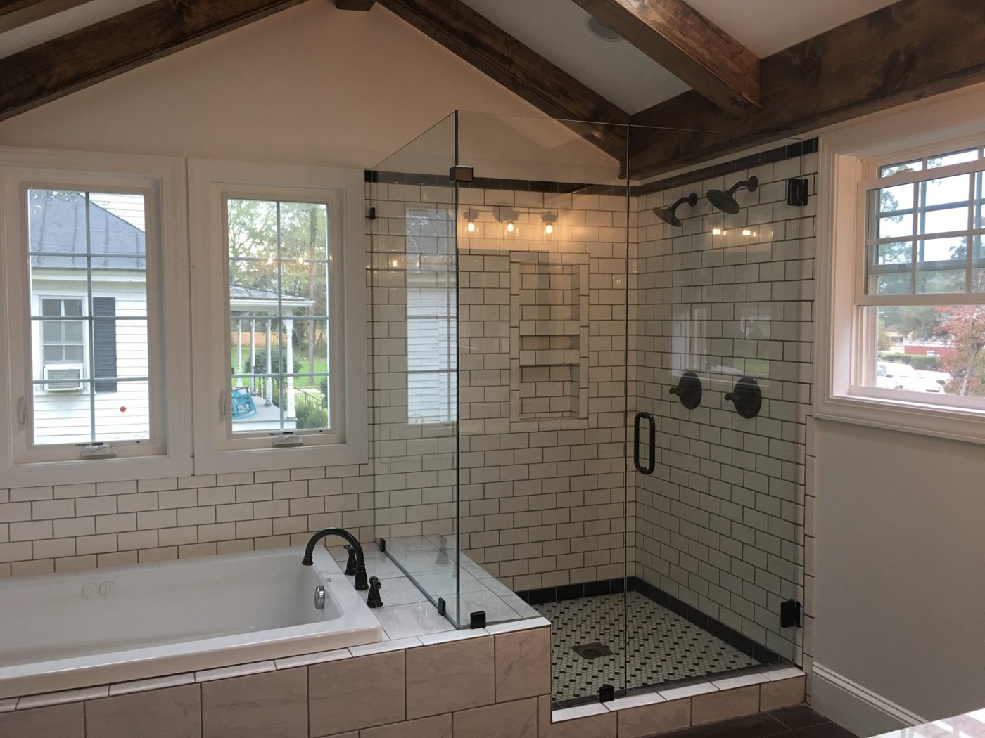 Sliding frameless glass shower with white subway tile and vanity, Virginia